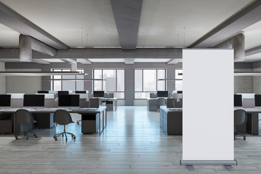 Modern coworking office interior with empty white roll-up mock up banner frame, wooden flooring, furniture, window with city view and daylight. 3D Rendering.