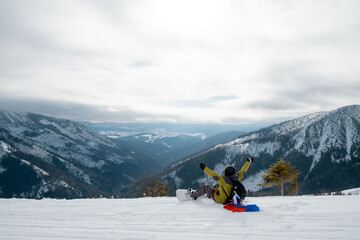 man snowboarder with slovakia flag at ski resort slope