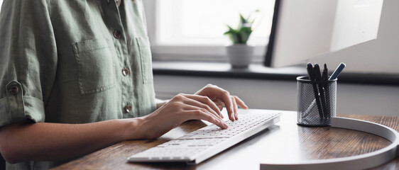 Woman hands typing on computer keyboard closeup, businesswoman or student girl using computer at...