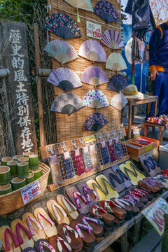 KYOTO, JAPAN- CIRCA 2018:Hand fans, bamboo cup and geta traditional Japanese wooden footwear normally wore by Japanese people sold in Kyoto, Japan.