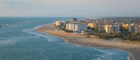 Aerial shot of sandy beach with umbrellas, typical adriatic shore.Summer vacation concept.Lido...