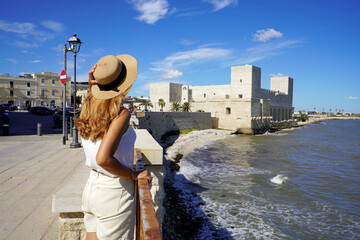 Visiting Apulia, Italy. Back view of tourist woman in Trani, Apulia, Italy. - obrazy, fototapety, plakaty