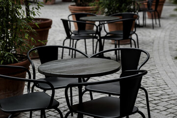 empty black tables and chairs of restaurant