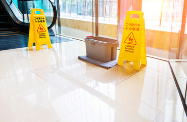 Yellow warning sign wet floor