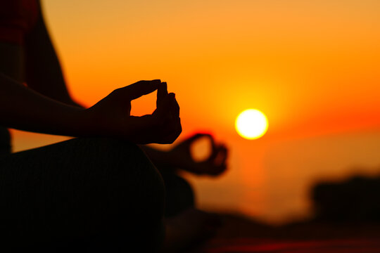 Yogi Hands At Sunset Doing Yoga On The Beach