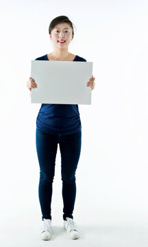 Full Length Young Woman Holding Blank Cardboard Isolated On White Background