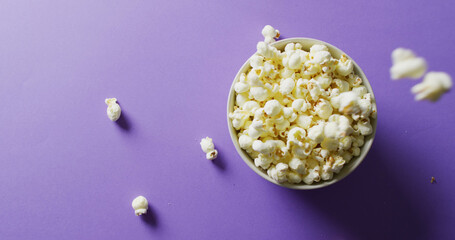 Image of close up of popcorn on purple background