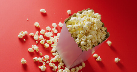 Image of close up of popcorn on red background