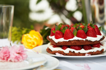 Strawberry cake on spring decorated table