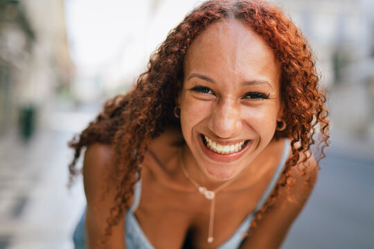 Cheerful Young Woman With Curly Hair