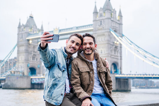 London, United Kingdom, A couple of guys taking selfie in front of Tower Bridge