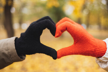 Hands with gloves making heart shape