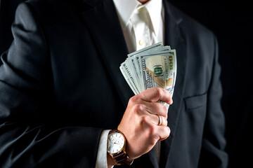 bankrupt man counts money in cash close-up with hands in front of him.