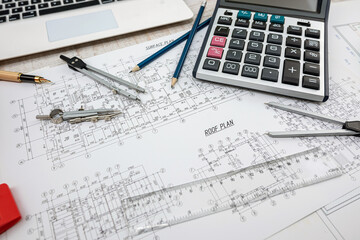 Building plans drawing with helmet and drawing tools.