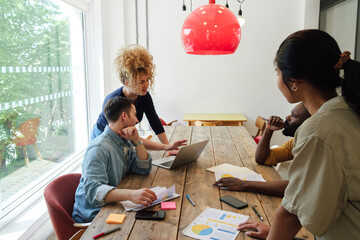 Creative business people having meeting in modern conference room discussing solutions