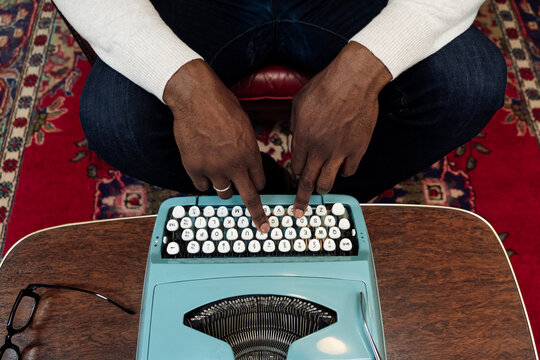 Hands of businessman typing on vintage typewriter