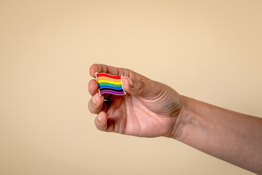 Rainbow Colored Miniature Flag Pin In Woman's Hand
