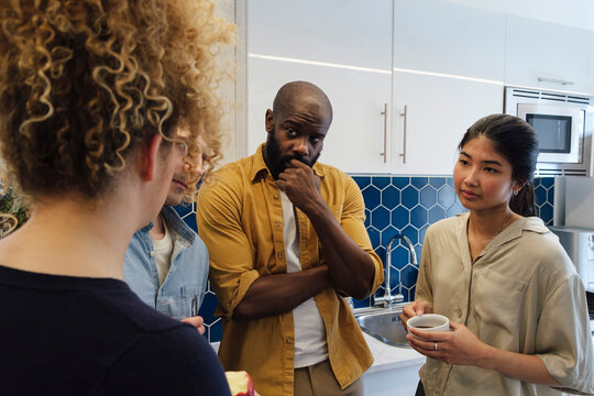 Business People Talking In Office Kitchen At Tea Break