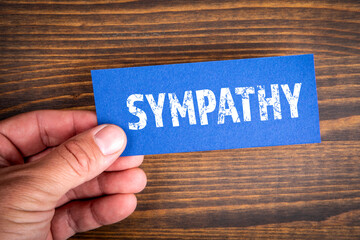 Sympathy. Blue piece of paper with a text in a man's hand
