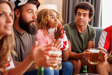 Group of friends watching football on TV