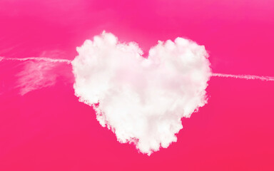 Heart shaped cloud in a pink sky with plane cupid arrow. Love symbol. Cloudscape. Valentine day card. Abstract art. Magic sign. Romantic relationship. Healthy cardio system. Heart muscle care concept