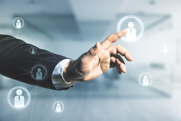 Double exposure of man hand presses on abstract virtual social network icons on blurred office background. Marketing and promotion concept