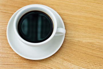 Top view of hot coffee on wooden table