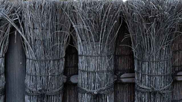 Dry armfuls of firewood background, bunches of dry branches of dark gray color