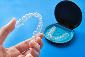 Transparent invisible dental aligners or braces applicable to orthodontic treatment and their containers. - obrazy, fototapety, plakaty
