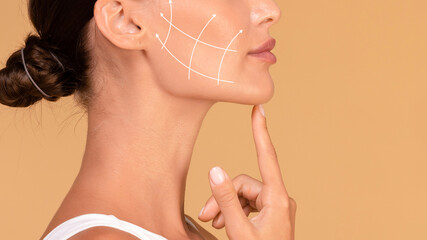 Lady touching chin, lifting arrows showing facial anti-aging treatment on skin, panorama, free space