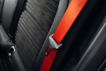 Sports car seatbelt close up. Modern car red seatbelt and leather comfortable seat 
