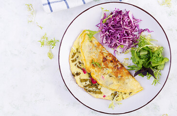 Ketogenic diet breakfast. Omelette with sorrel and fresh salad. Top view, copy space