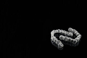 Transparent, invisible dental aligners or braces applicable to orthodontic treatment are placed on...