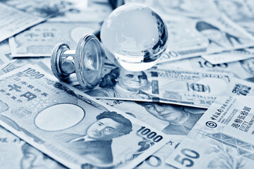 Stethoscope and glass globe on many banknotes