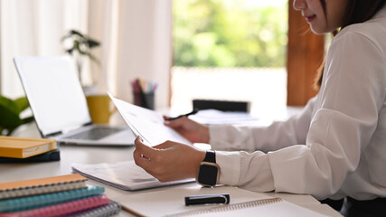 Cropped shot of young creative woman working on mobile application software design project at modern office