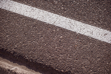 Fototapeta premium Roadside closeup with a white painted line