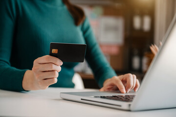 Woman hands holding credit card with digital layer effect diagram as Online shopping concept