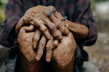 Close up of male wrinkled hands, old man is wearing.