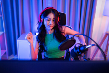 Asian young audio DJ woman sing a song on microphone to broadcasting. 