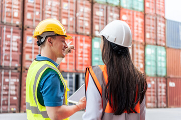 Caucasian business man and woman worker working in container terminal. 