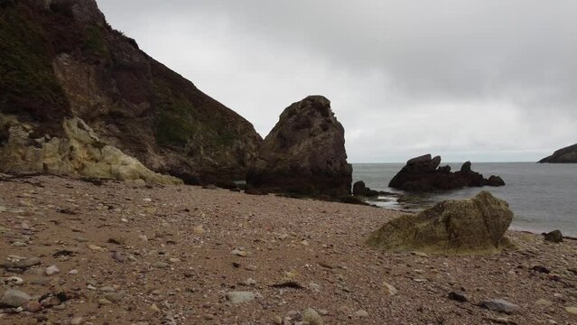 Drone Flying Low Over Beautiful Rocky Beach, Porth Wen, United Kingdom
