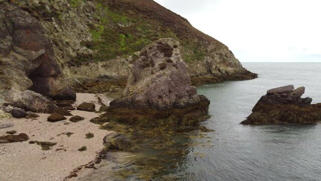 Amazing Rock Formation With Green Algae On Coastline Of Porth Wen Beach, United Kingdom