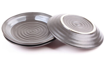 Empty black ceramic plate isolated on white