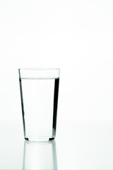 Glass beaker filled with water on a white background