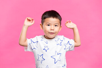 Asian Happy little son hand raise up over pink background