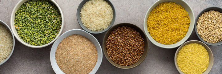 Various grain cereals in bowls banner, top view