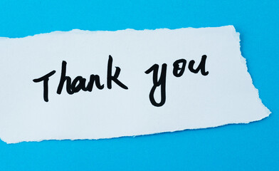 Handwritten text Thank you on torn paper