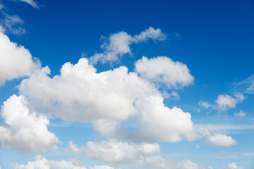 Obraz na płótnie Canvas White fluffy clouds on blue sky