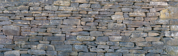 Grey dry stone wall texture, gray stone garden wall background