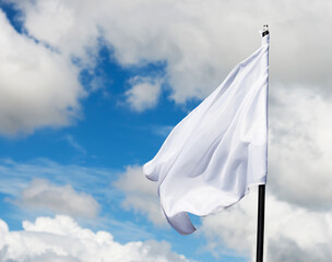 White flag flying against blue sky